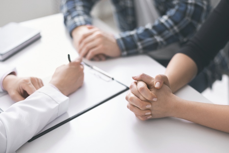 Doctor writing prescription and treatment plan to patients