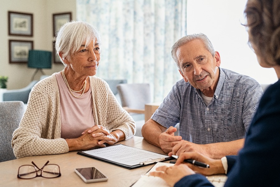 Senior couple planning their investments with financial advisor